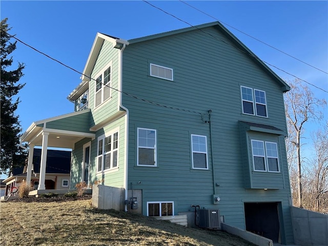 rear view of property with central AC unit