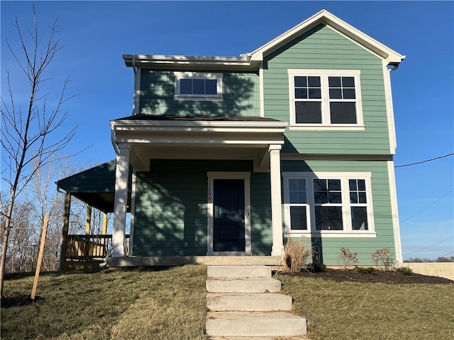 view of front facade featuring covered porch and a front lawn