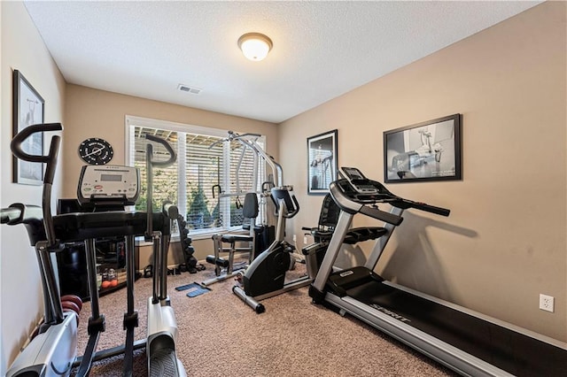 exercise room with a textured ceiling