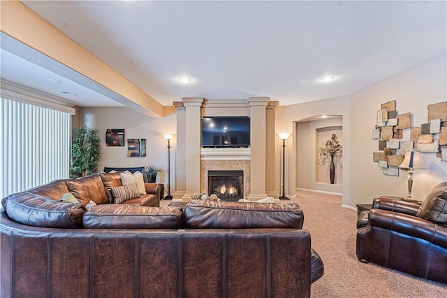 living room featuring decorative columns and carpet flooring