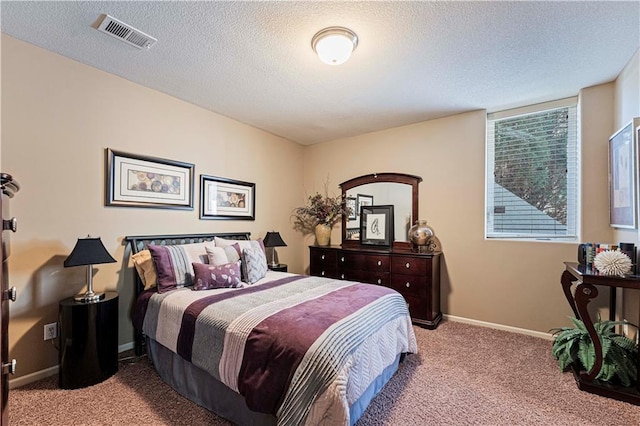 carpeted bedroom with a textured ceiling