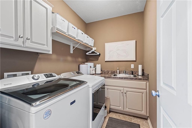 laundry room featuring cabinets, washer and clothes dryer, and sink