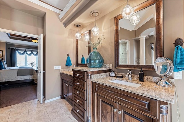 bathroom with ornate columns, crown molding, tile patterned floors, and vanity