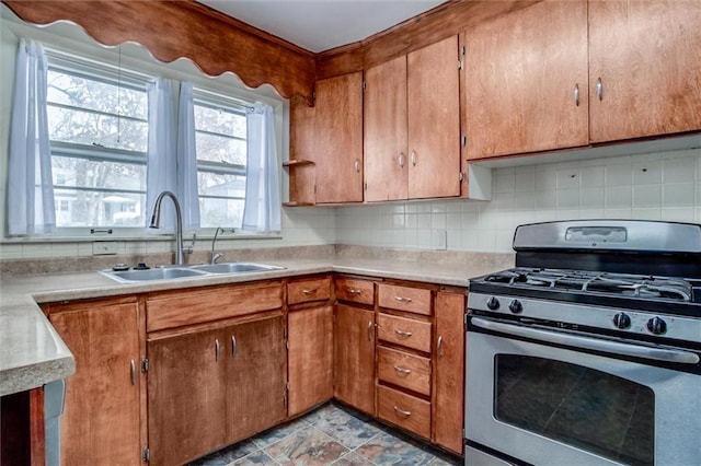 kitchen with sink, stainless steel range with gas stovetop, and decorative backsplash