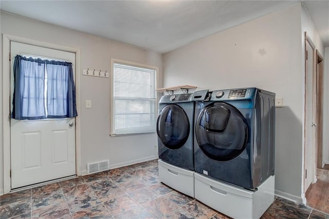 washroom featuring washer and dryer