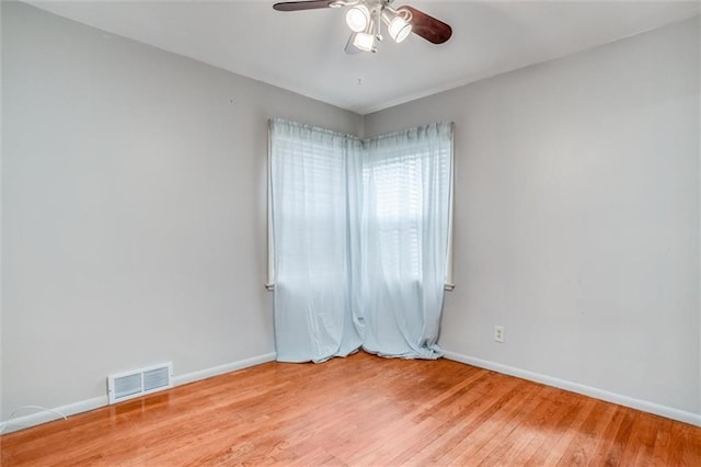 spare room with ceiling fan and light wood-type flooring