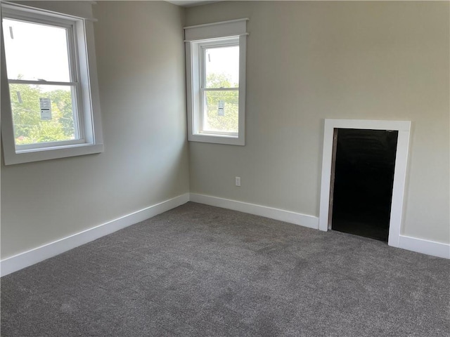 empty room with carpet floors and baseboards