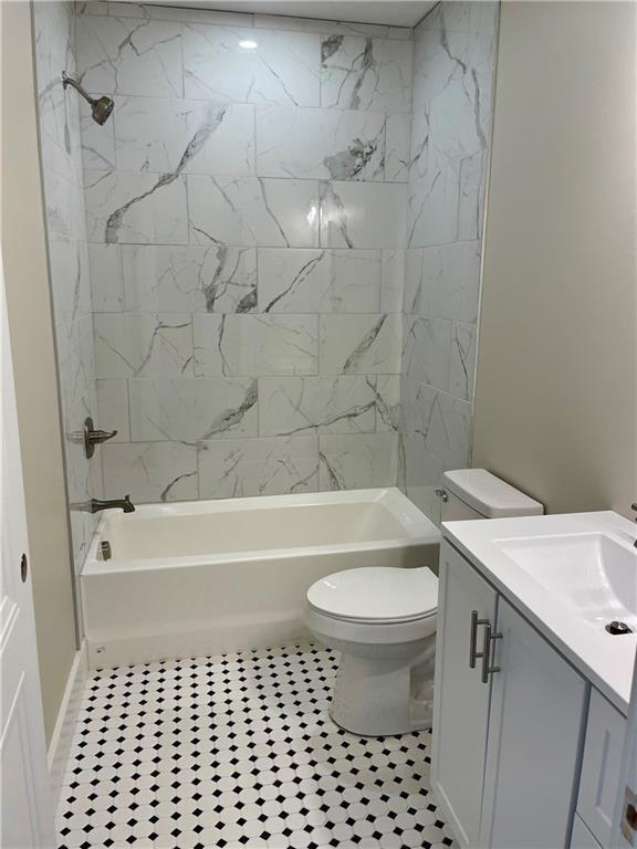 full bath featuring vanity, shower / bathing tub combination, tile patterned floors, and toilet