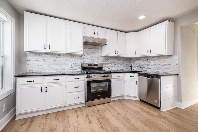 kitchen with white cabinetry, appliances with stainless steel finishes, and light wood-type flooring