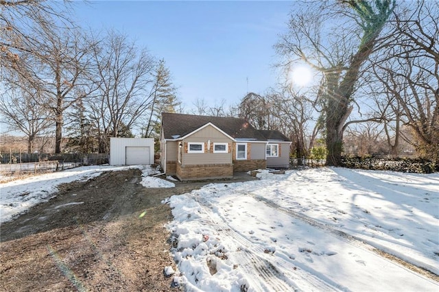 view of front of home featuring a garage and an outdoor structure