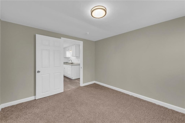 unfurnished bedroom with carpet flooring and sink