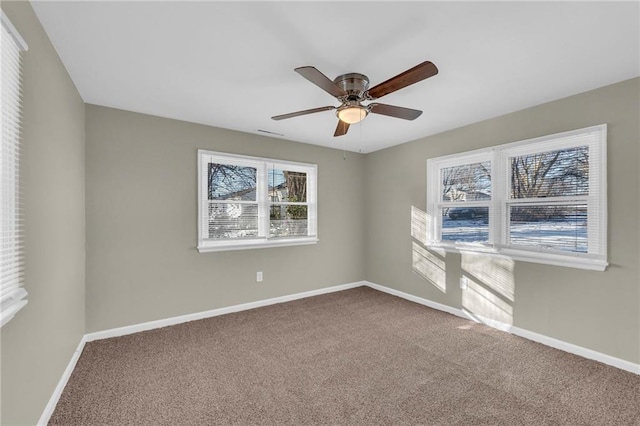 unfurnished room with ceiling fan and carpet