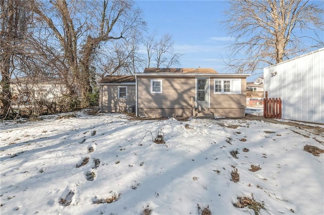 view of snow covered rear of property