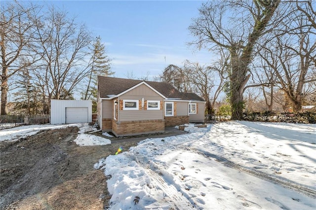 view of front of property with a garage and an outbuilding