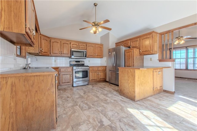 kitchen with lofted ceiling, sink, appliances with stainless steel finishes, ceiling fan, and decorative backsplash