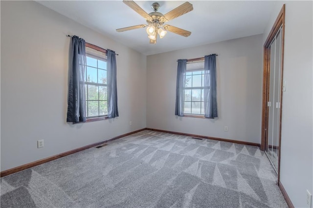 interior space with a closet, ceiling fan, and carpet flooring