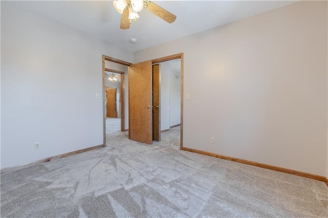 carpeted empty room featuring ceiling fan