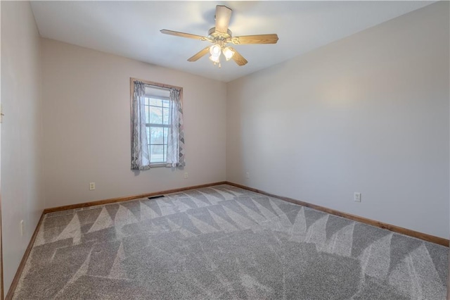 carpeted empty room featuring ceiling fan