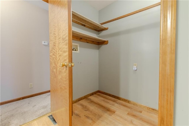 laundry area with washer hookup and light hardwood / wood-style floors