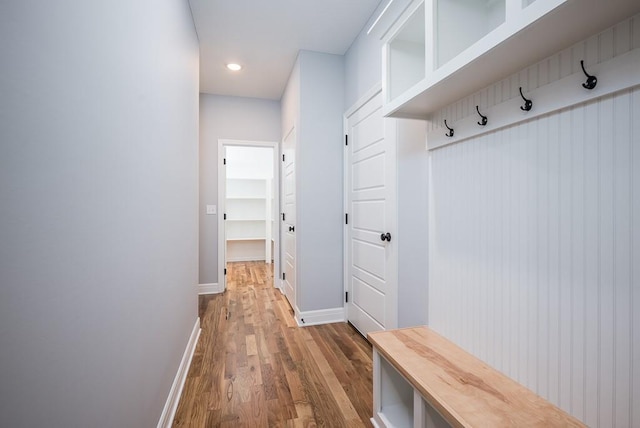 mudroom with recessed lighting, baseboards, and wood finished floors