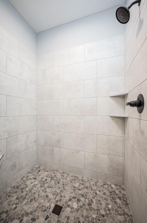 bathroom with a tile shower