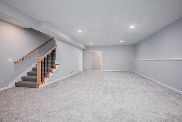 interior space featuring recessed lighting, stairs, baseboards, and light colored carpet