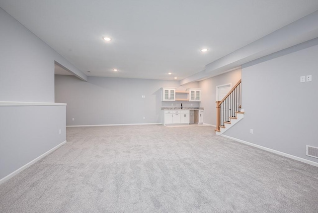 unfurnished living room with visible vents, stairs, baseboards, and recessed lighting