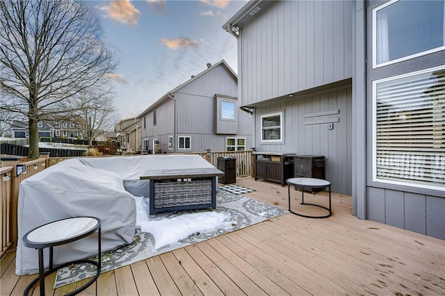 deck at dusk with a fire pit