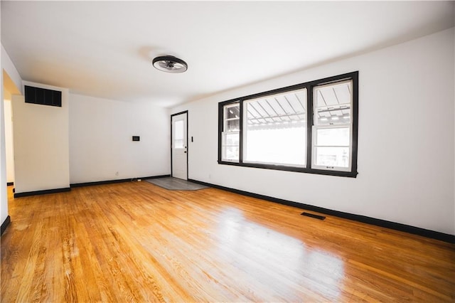 unfurnished room with light wood-type flooring