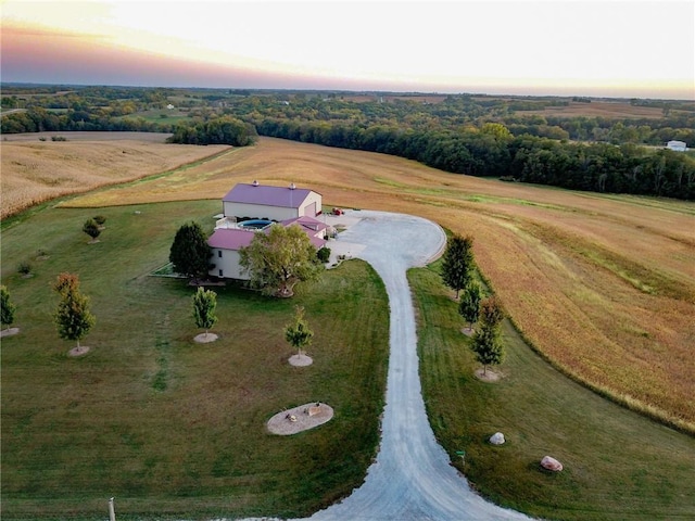 aerial view at dusk featuring a rural view