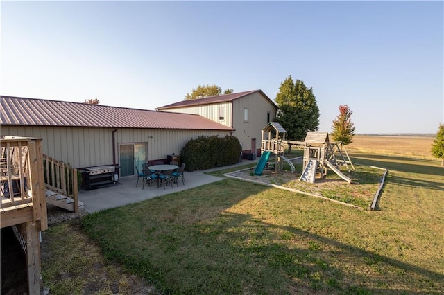 view of yard with a patio and a playground