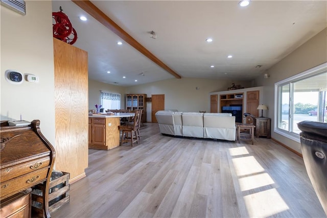 living room featuring light hardwood / wood-style floors and lofted ceiling with beams