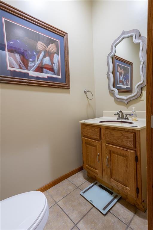 bathroom featuring tile patterned flooring, vanity, and toilet