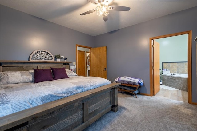 bedroom with ensuite bath, ceiling fan, and carpet flooring