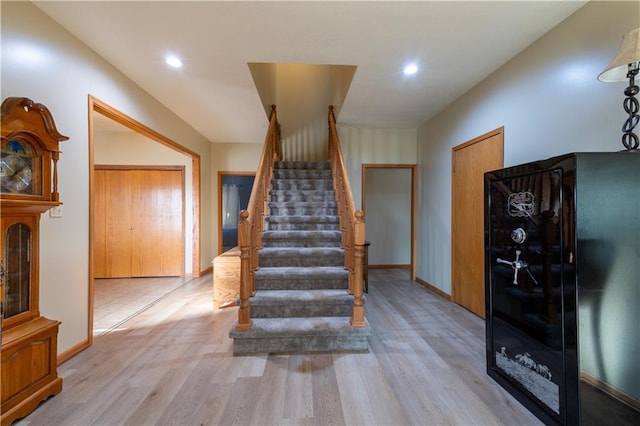 staircase with hardwood / wood-style floors