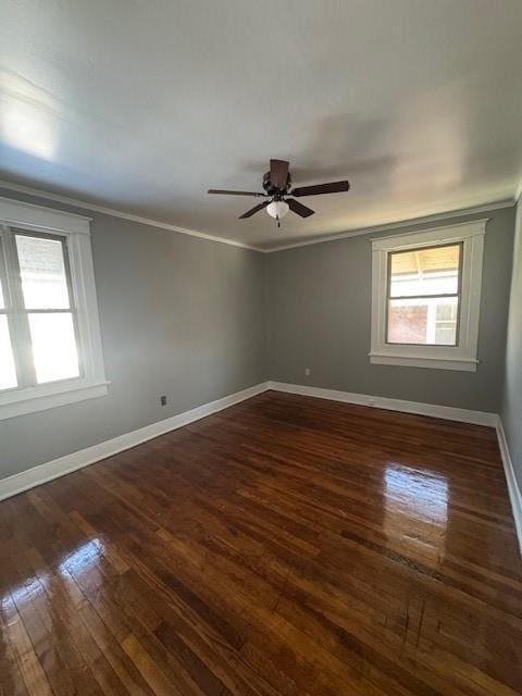 empty room featuring ornamental molding, dark hardwood / wood-style floors, and ceiling fan