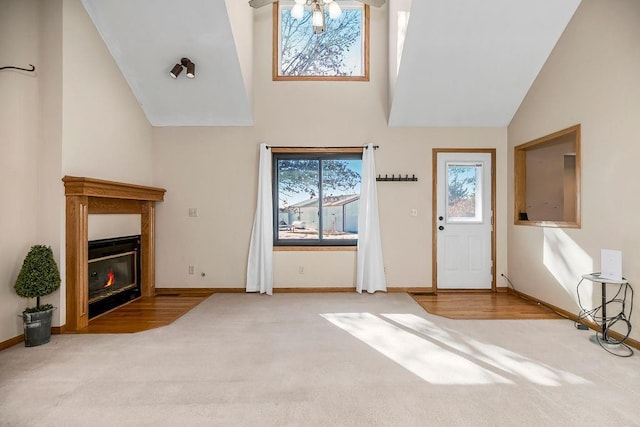 unfurnished living room featuring ceiling fan and carpet flooring