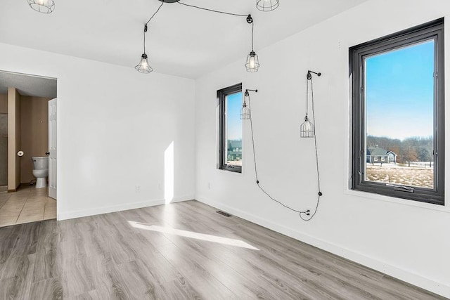 unfurnished room featuring light hardwood / wood-style floors