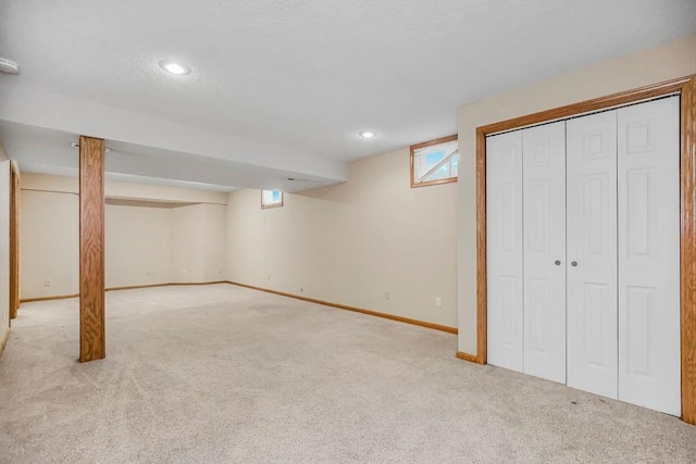 basement with light colored carpet and plenty of natural light