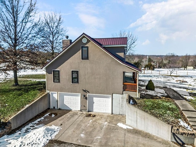 view of snowy exterior with a garage