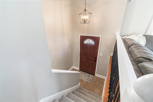 foyer entrance featuring light tile patterned floors and a notable chandelier