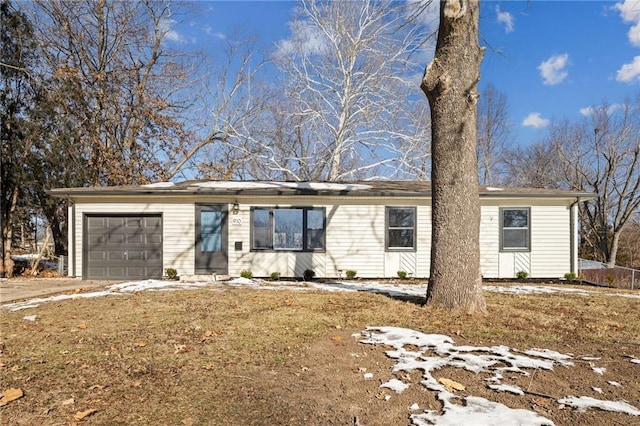 single story home featuring a garage and a front lawn