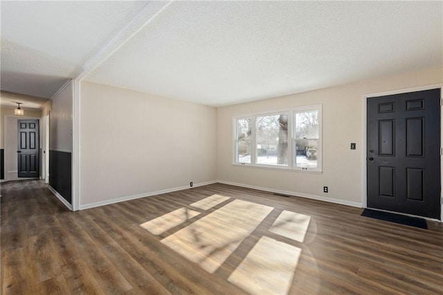 entrance foyer with dark hardwood / wood-style floors