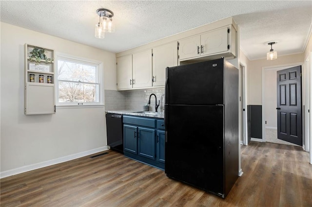 kitchen featuring sink, black appliances, white cabinets, and blue cabinets