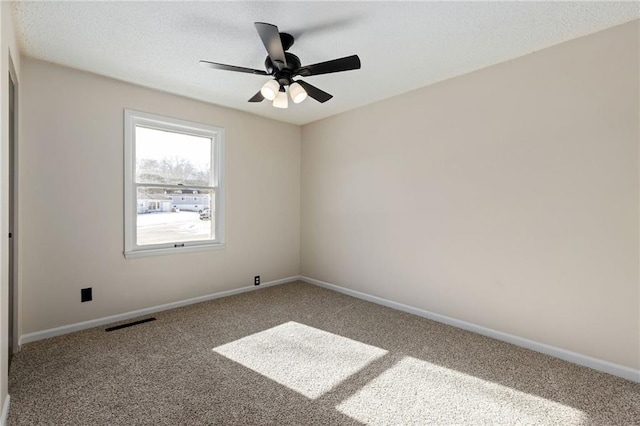 carpeted spare room with ceiling fan