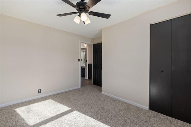 unfurnished bedroom featuring carpet, ceiling fan, and a closet