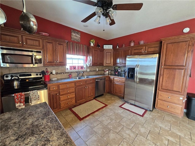 kitchen with sink, pendant lighting, ceiling fan, stainless steel appliances, and backsplash