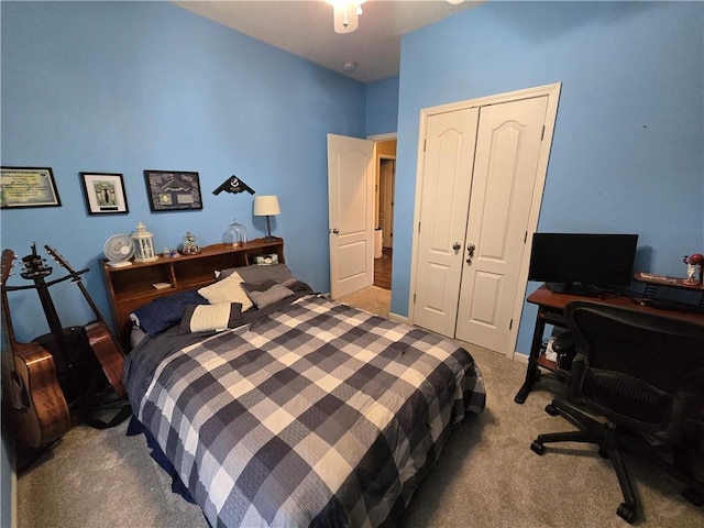 carpeted bedroom featuring a closet and ceiling fan