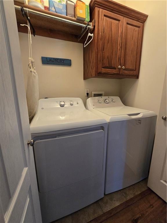 laundry area with cabinets, dark hardwood / wood-style floors, and separate washer and dryer