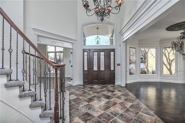 foyer entrance with a towering ceiling and a notable chandelier